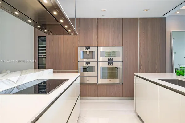 a kitchen with stainless steel appliances kitchen island a large counter top