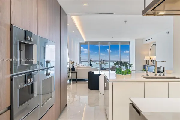 a kitchen with refrigerator and cabinets
