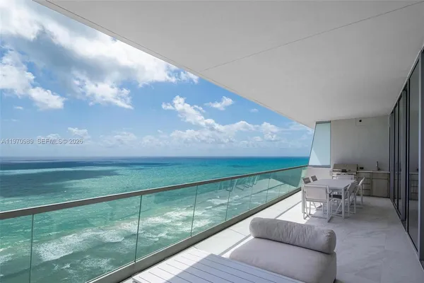 a balcony with an outdoor space and seating