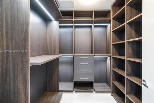 a bedroom with a bed lamp and window