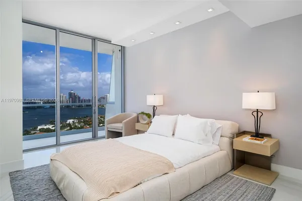 a bedroom with a bed and a lamp