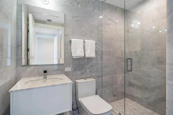 a bathroom with a sink toilet and a mirror