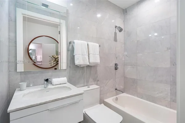 a bedroom with a bed and a chair