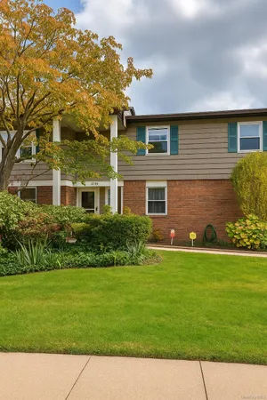 a front view of a house with a garden
