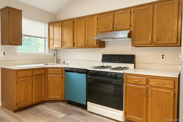 a kitchen with granite countertop cabinets stainless steel appliances and a sink