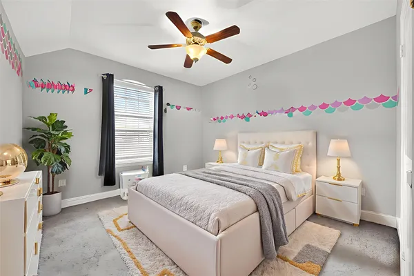 a bedroom with a large bed and a chandelier