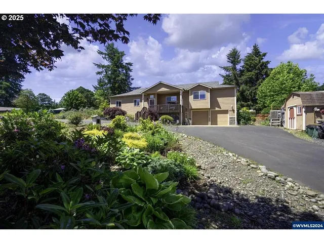 a view of a house with a yard and garden