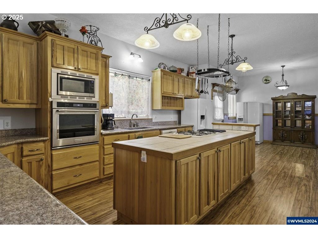 5465 Sams Place Southeast Turner, OR 97392 - Photo 13 of 46 a kitchen with a sink cabinets and stainless steel appliances