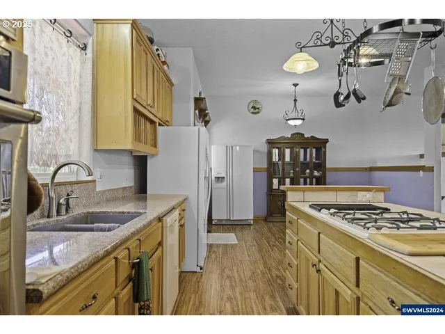 a kitchen with a sink a stove and cabinets