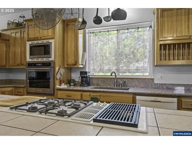 a kitchen with stainless steel appliances granite countertop a stove and a sink