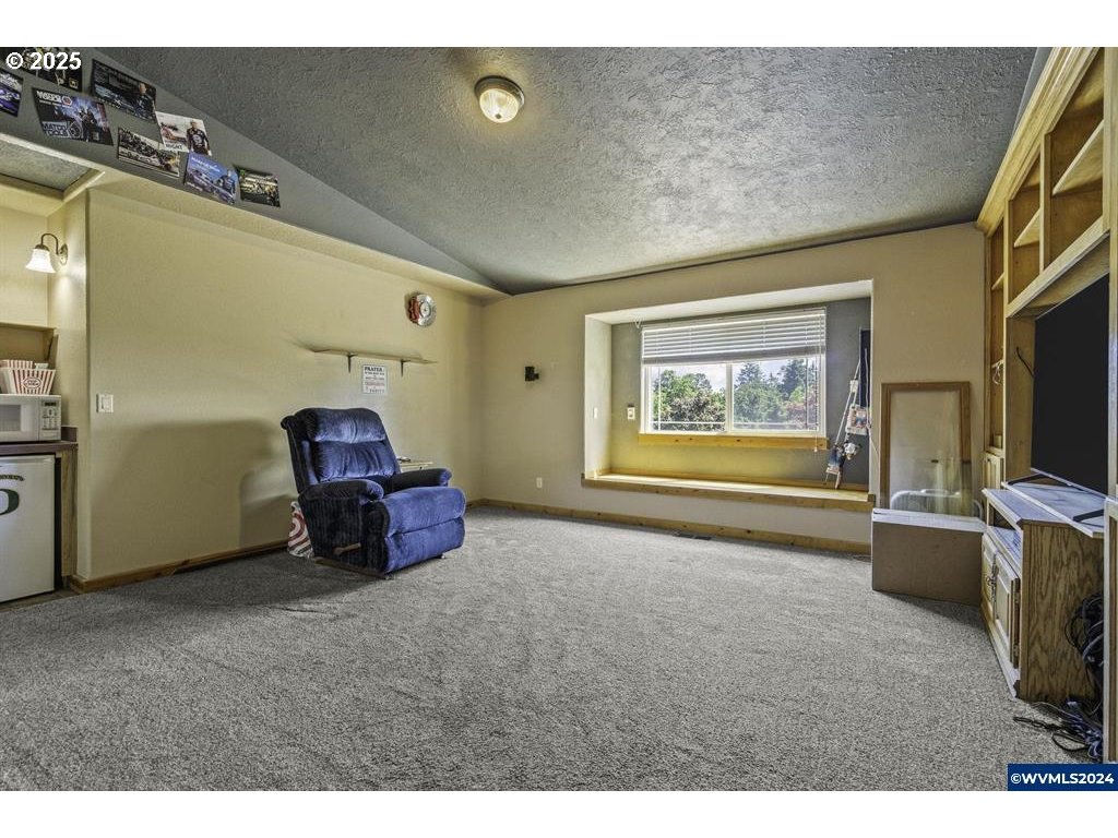5465 Sams Place Southeast Turner, OR 97392 - Photo 19 of 46 a living room with furniture a flat screen tv and a window