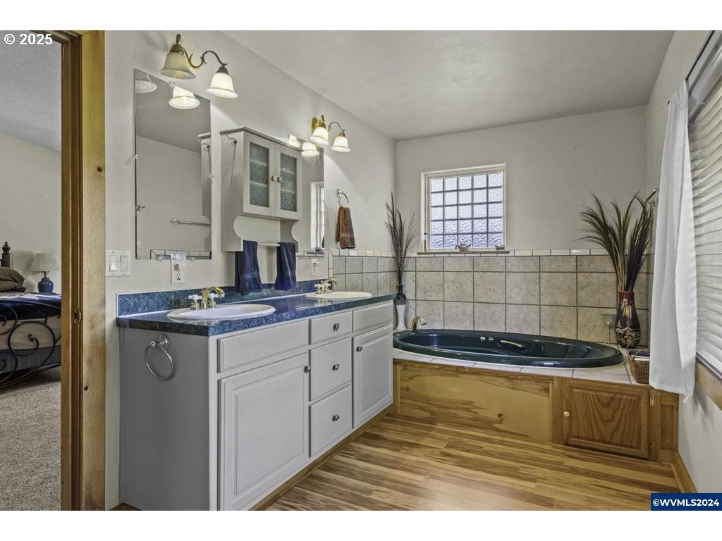5465 Sams Place Southeast Turner, OR 97392 - Photo 24 of 46 a bathroom with a bathtub sink and mirror