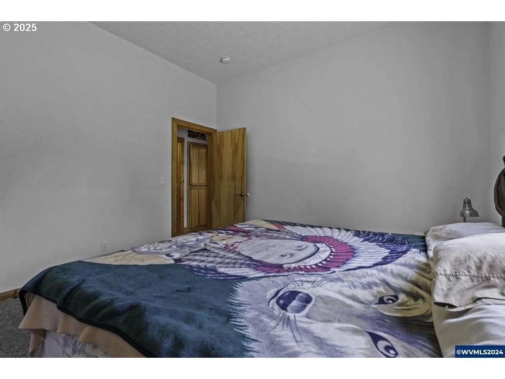 5465 Sams Place Southeast Turner, OR 97392 - Photo 25 of 46 a bedroom with a bed and a dresser