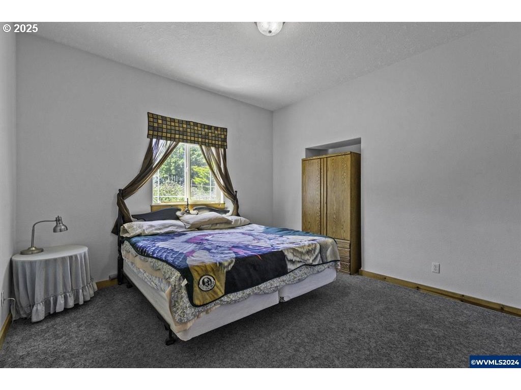 5465 Sams Place Southeast Turner, OR 97392 - Photo 26 of 46 a bedroom with a bed windows and a dresser