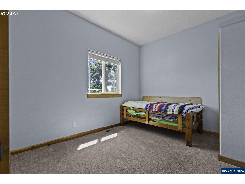 5465 Sams Place Southeast Turner, OR 97392 - Photo 29 of 46 a bedroom with bed and a window