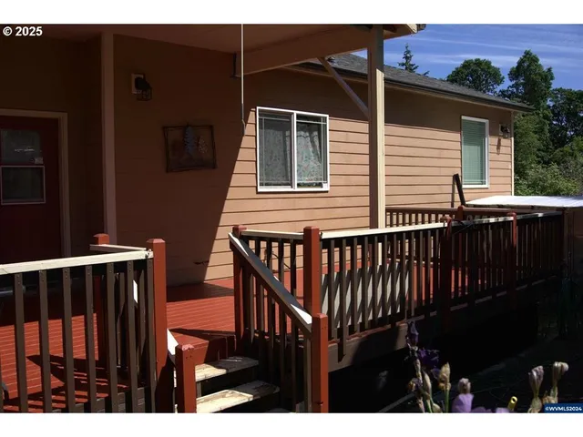a view of a house with wooden deck