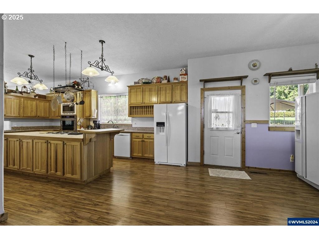 5465 Sams Place Southeast Turner, OR 97392 - Photo 5 of 46 a view of open kitchen with wooden floors