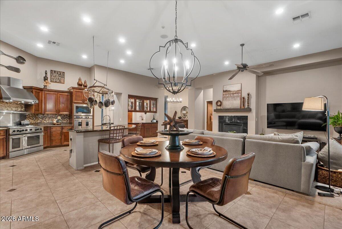 6427 South Magic Court Gilbert, AZ 85298 - Photo 9 of 71 a view of a dining room with furniture and a kitchen