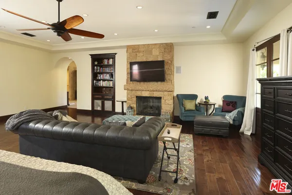 a spacious bathroom with a tub sink and mirror