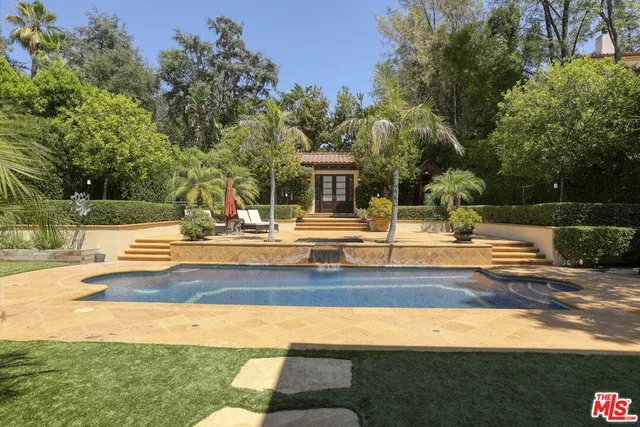 an aerial view of a house with a swimming pool