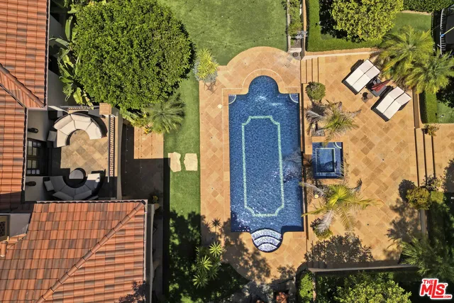 a view of a patio with table and chairs potted plants and a large tree