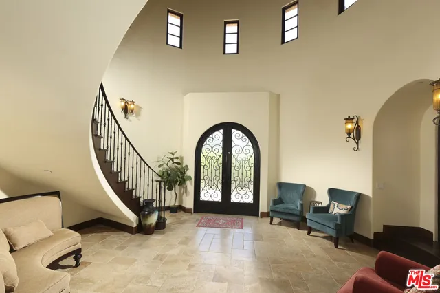 a view of a hallway with livingroom and furniture