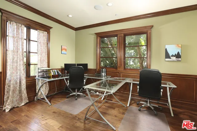 a view of a dining room with furniture wooden floor and chandelier