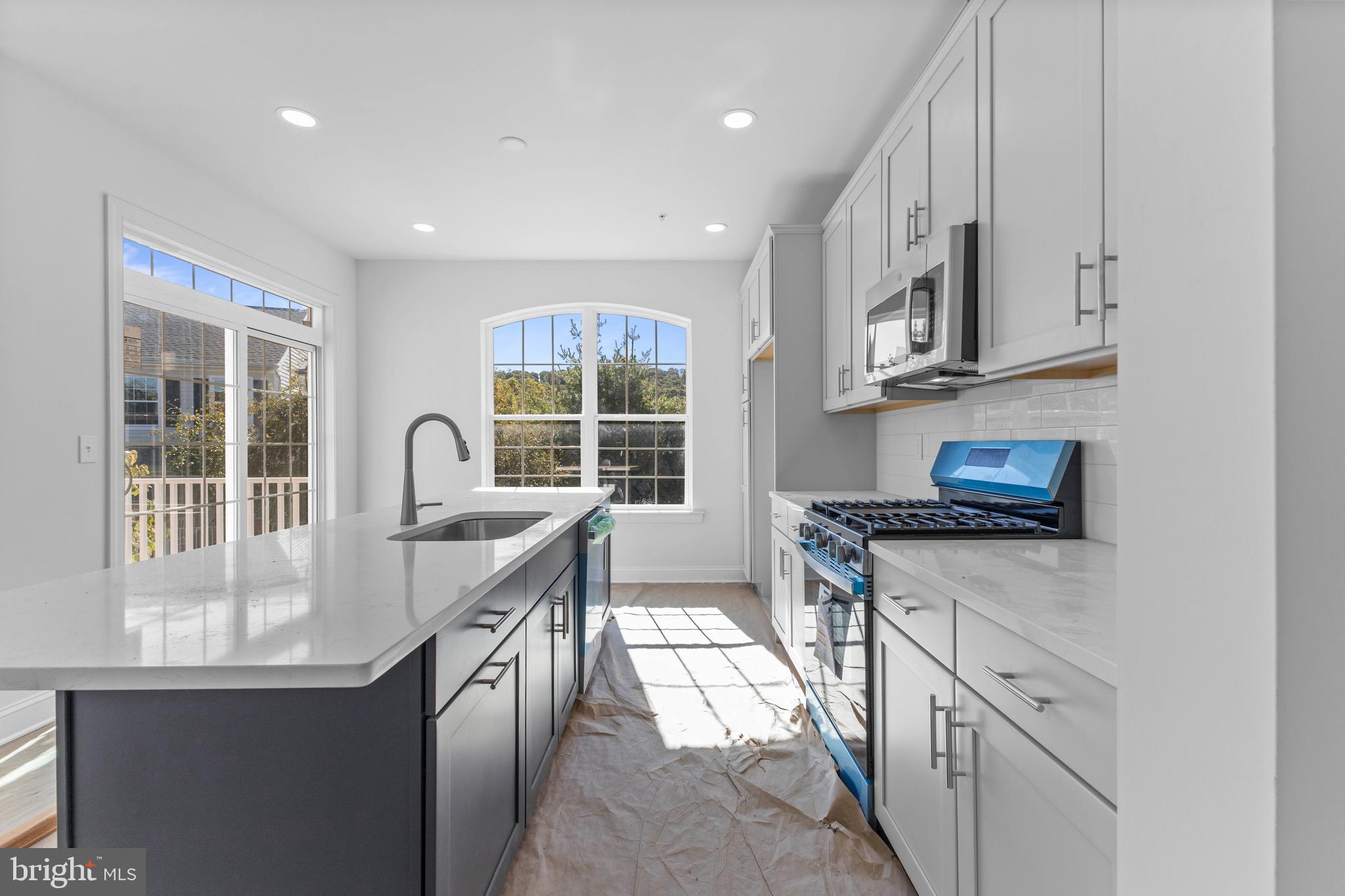 868 Veneto Court, Unit 66 Easton, PA 18040 - Photo 13 of 37 a kitchen with stainless steel appliances granite countertop a stove a sink and a microwave