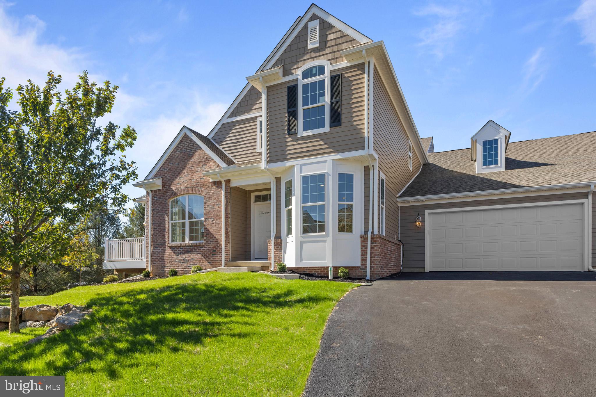 868 Veneto Court, Unit 66 Easton, PA 18040 - Photo 2 of 37 a front view of a house with a yard