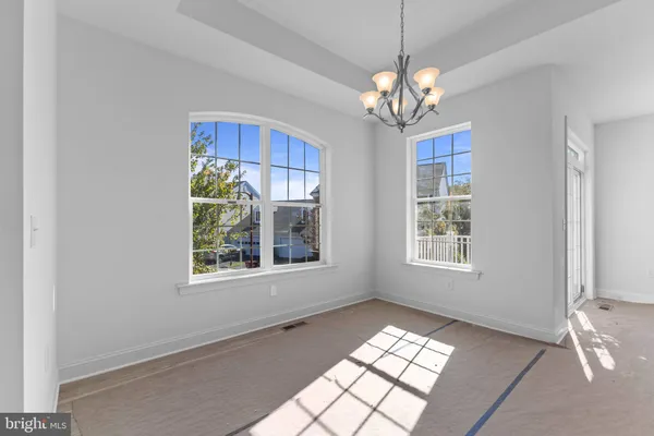 a view of a room with windows and chandelier