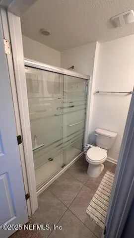 a bathroom with a shower and a toilet