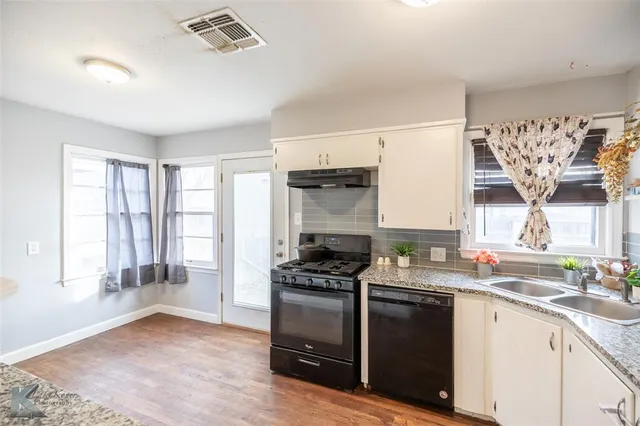 a kitchen with a stove a sink and a refrigerator