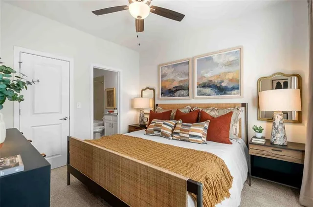 a bedroom with a large bed and a chandelier