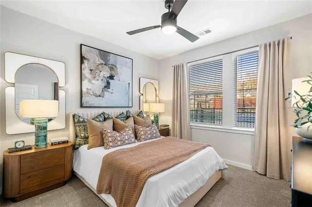 a bedroom with a bed and a painting on the wall