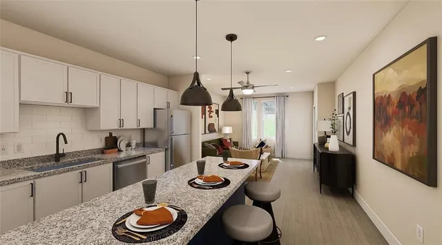 a kitchen with stainless steel appliances granite countertop a sink a stove and refrigerator