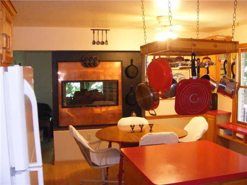 373 Hawthorne Road Pittsburgh, PA 15209 - Photo 6 of 25 Kitchen. Note Copper Covered see through Gas or Log Fireplace in background