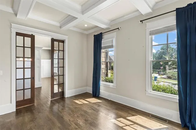 an empty room with windows and closet