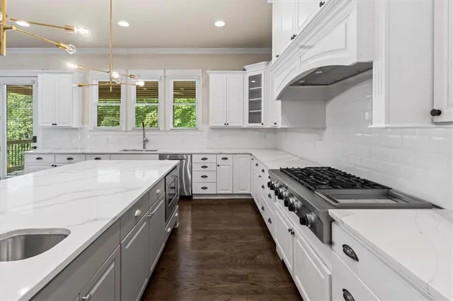 a kitchen with a sink stove and cabinets