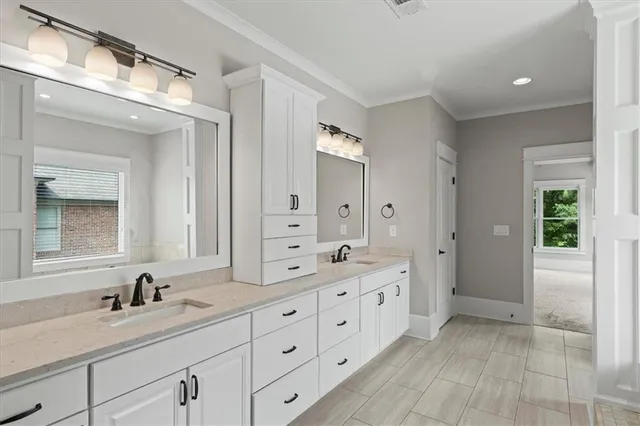a spacious bathroom with a granite countertop sink mirror and double
