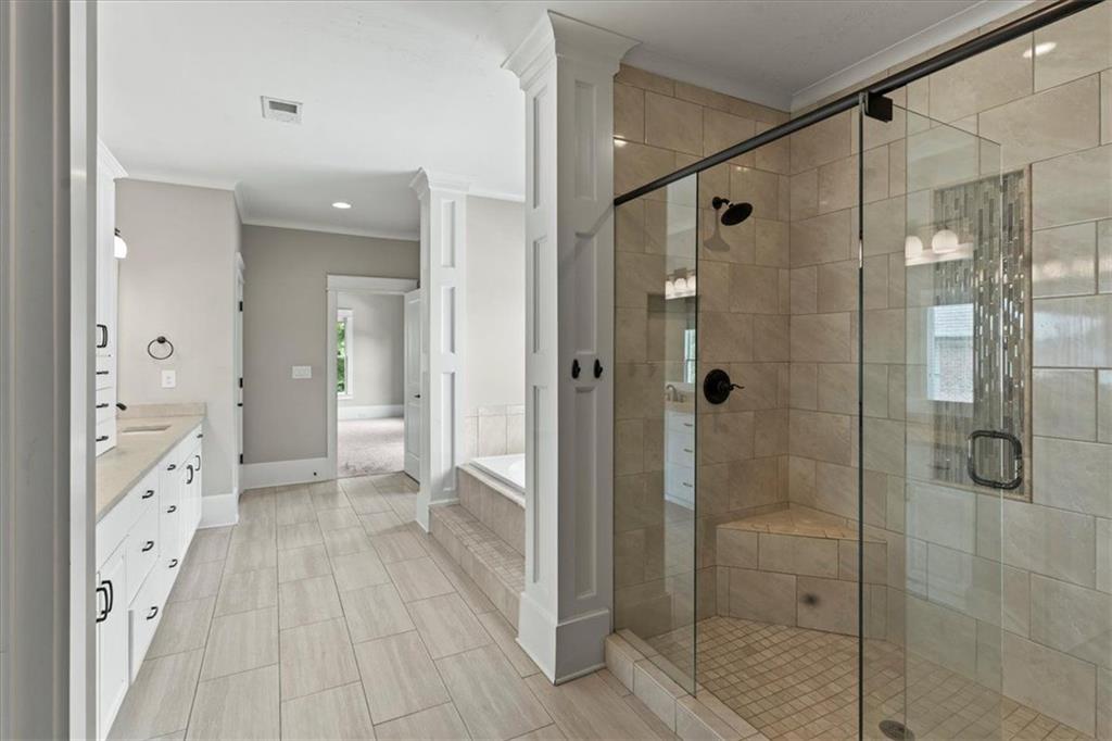 2996 Cambridge Hill Drive Dacula, GA 30019 - Photo 25 of 49 a bathroom with a shower and a glass door shower