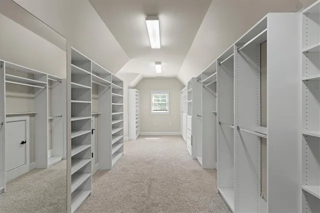 a view of walk in closet with empty racks