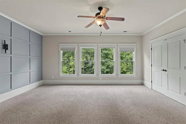 a view of room with a ceiling fan and window