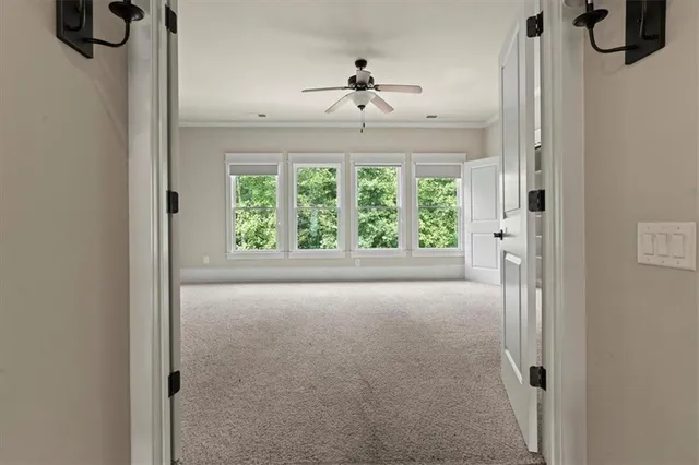 a view of hallway with windows and chandelier