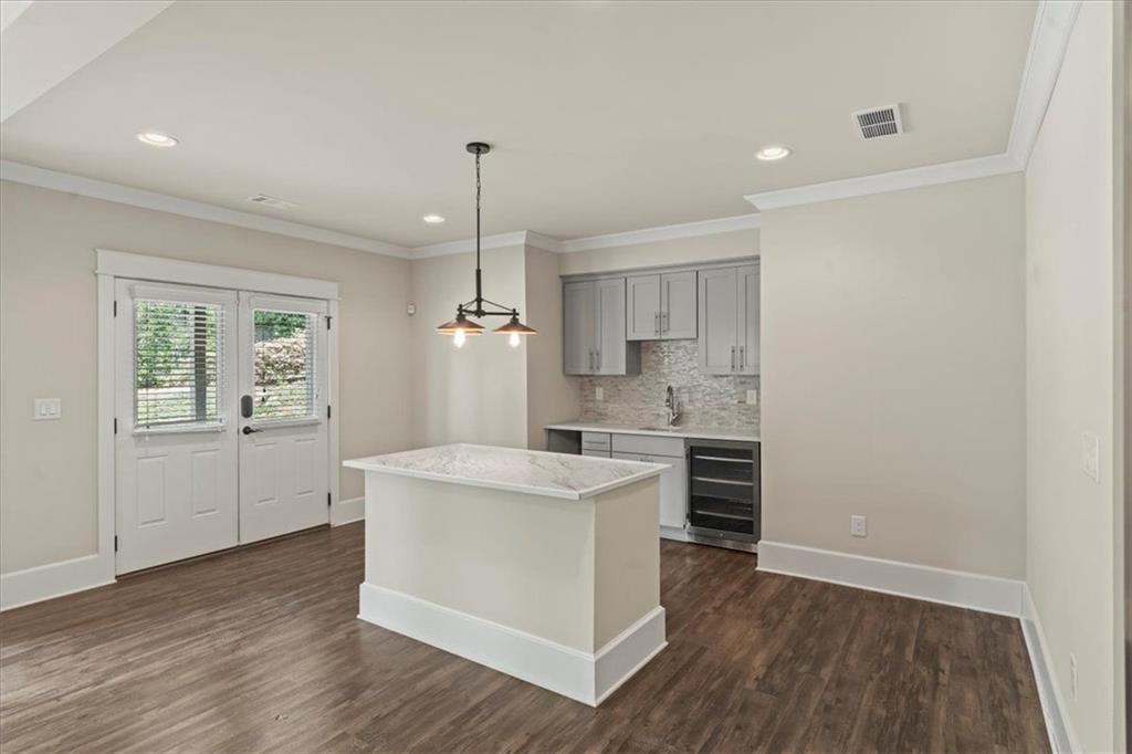 2996 Cambridge Hill Drive Dacula, GA 30019 - Photo 31 of 49 a kitchen with a sink a stove cabinets and wooden floor