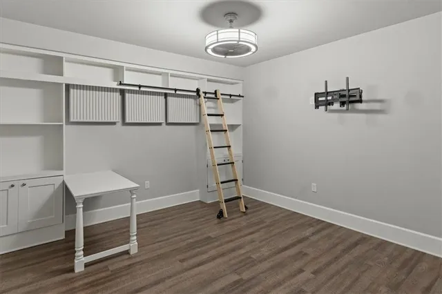 a view of a room with wooden floor and cabinet