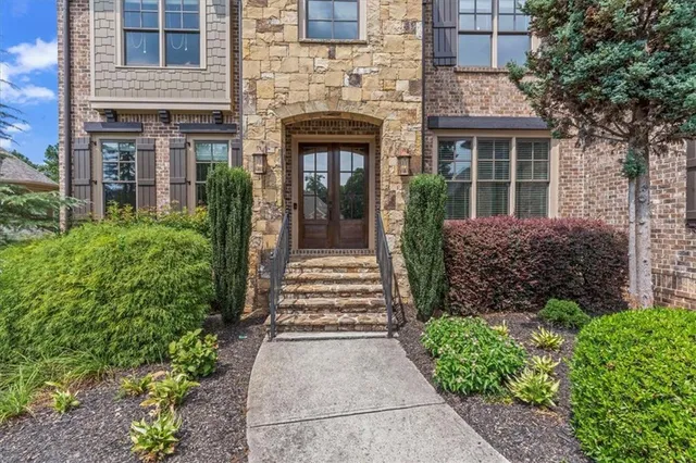 a front view of a house with a garden