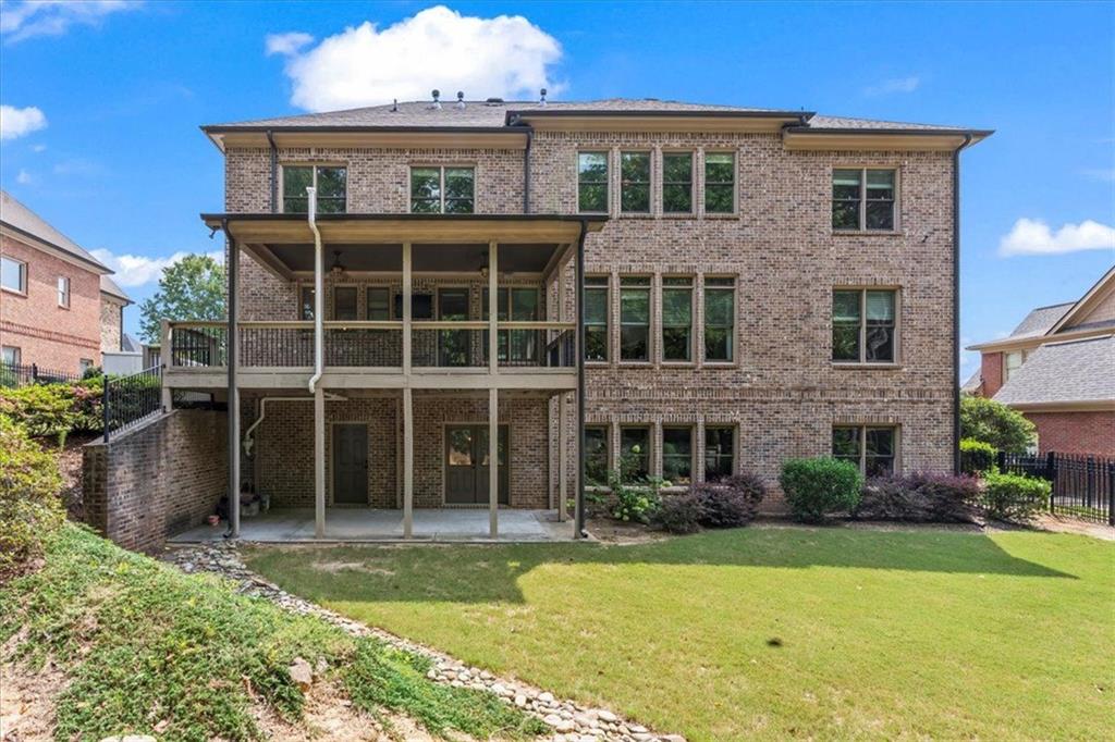 2996 Cambridge Hill Drive Dacula, GA 30019 - Photo 37 of 49 a view of a brick house with a yard plants and large tree