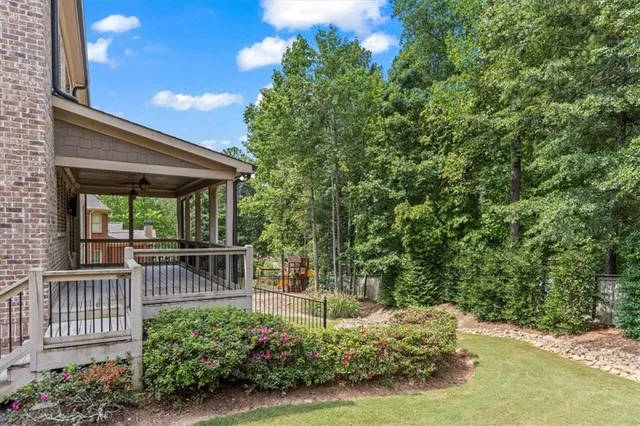 a view of a porch with furniture and garden