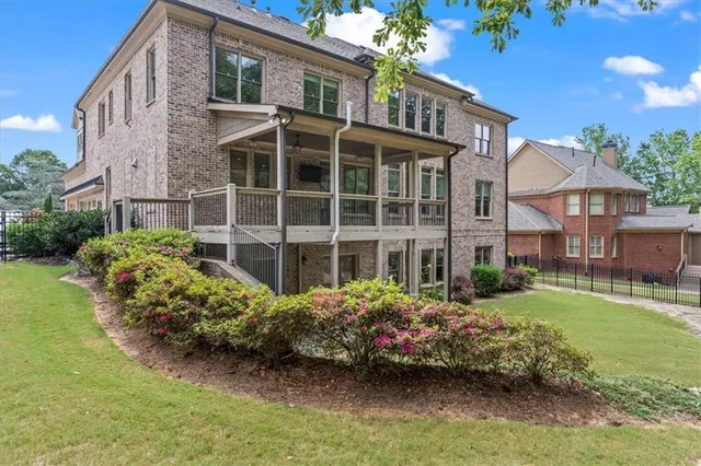 a front view of a house with a garden and plants