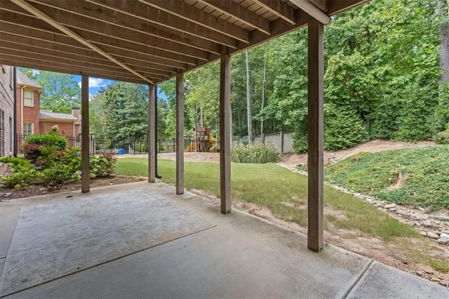 a view of a house with backyard and porch